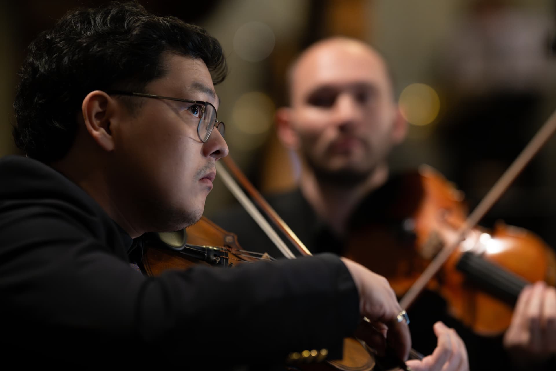 Violinist of the Empyrean Orchestra in profile during the concert