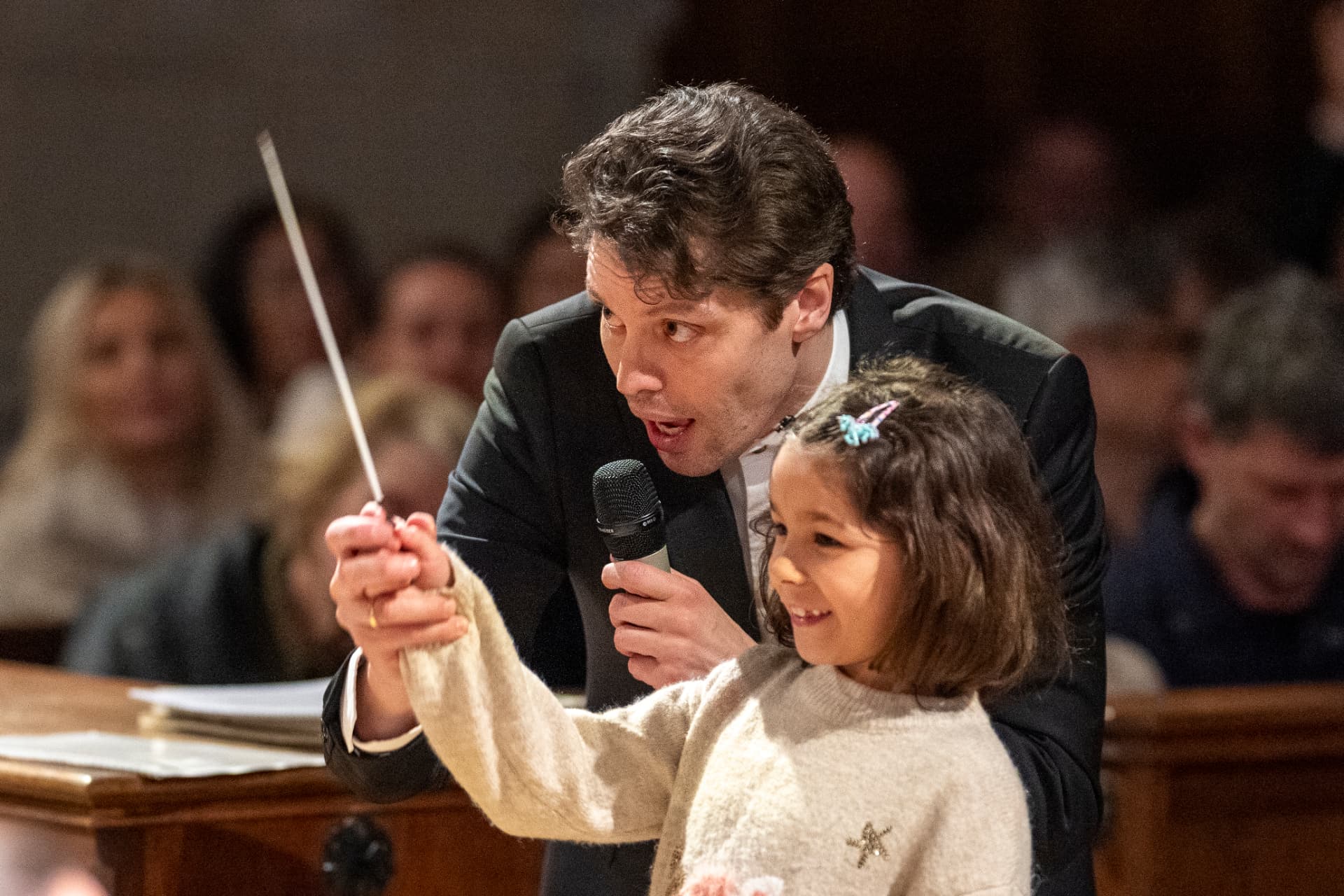 Kevin Griffiths lets a child conduct the orchestra
