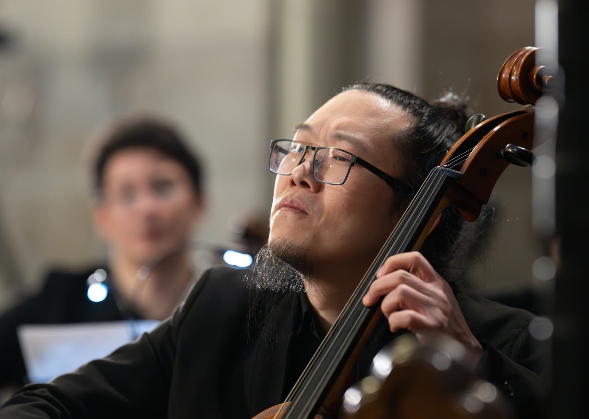 Cellist of the Empyrean Orchestra in concert